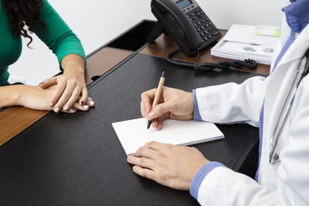 close up doctor writing prescription